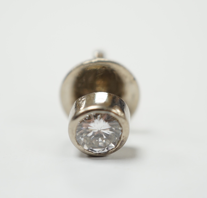 A white metal mounted solitaire diamond set tie stud, the stone measuring approximately 5mm in diameter, gross weight 1.6 grams. Good condition.